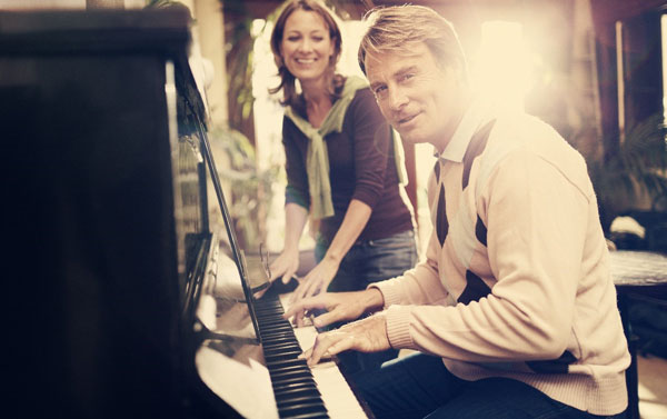 Man and woman playing piano