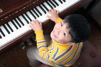 Smiling Boy Plays Piano