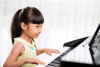 Young Girl Plays Piano