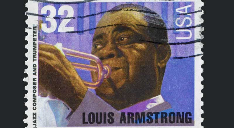 A 1995 USA stamp with an image of Louis Armstrong playing the trumpet