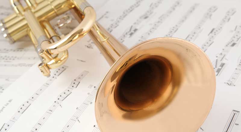 A trumpet on top of sheet music