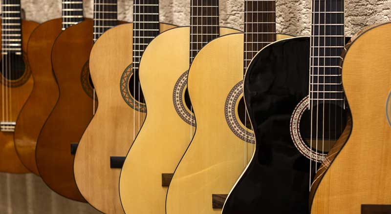 Close-up of eight guitars on display
