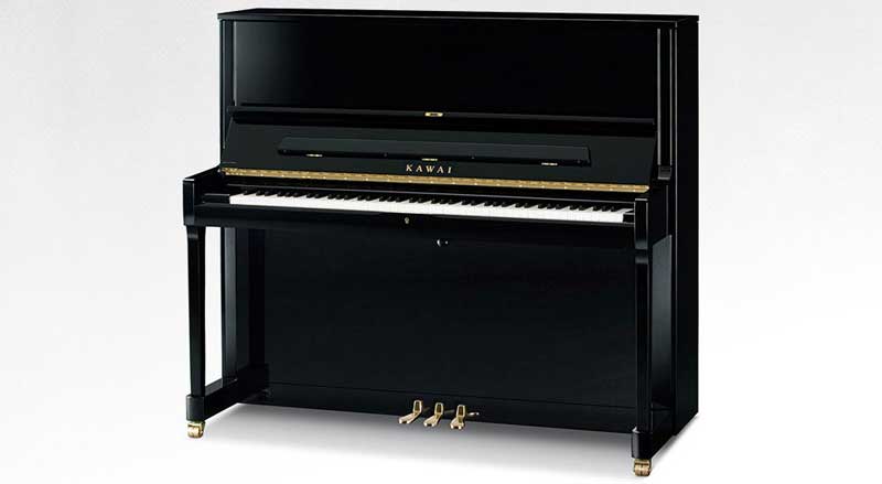 polished, black Kawai upright piano with white background